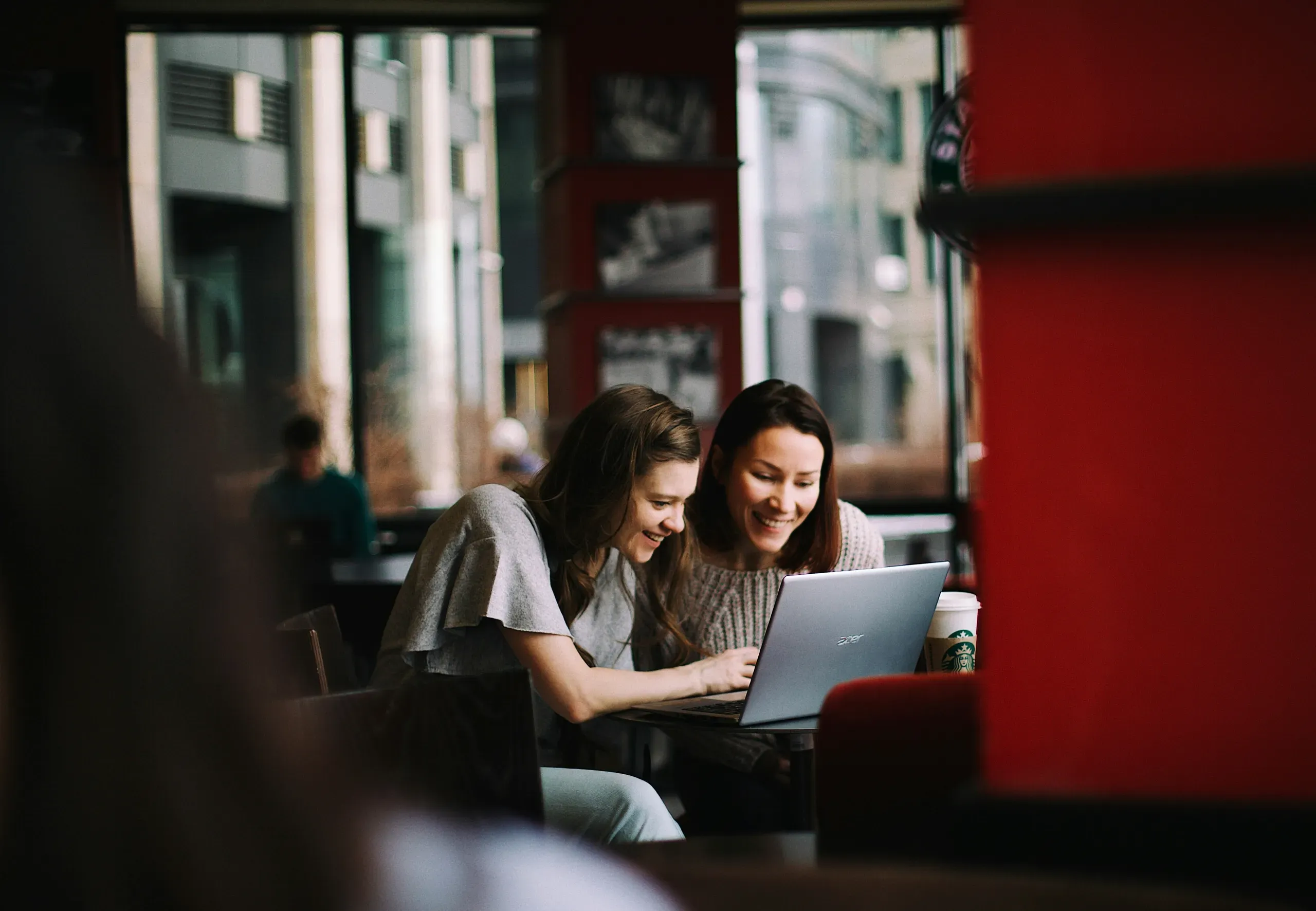 Two entrepreneurs working on their about section seated on a sofa 